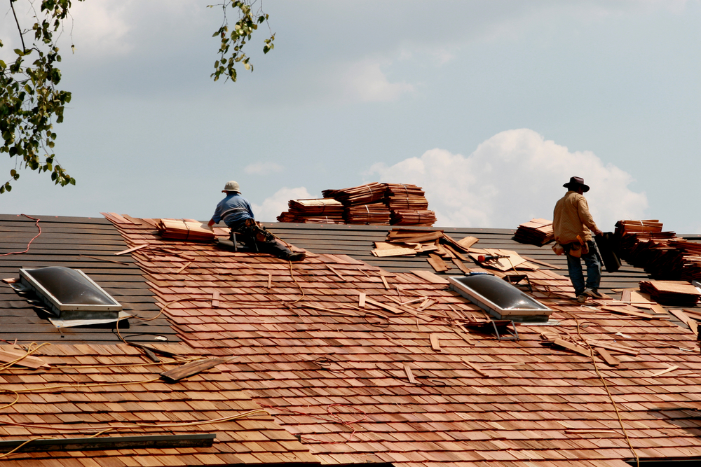 workers replacing shingles