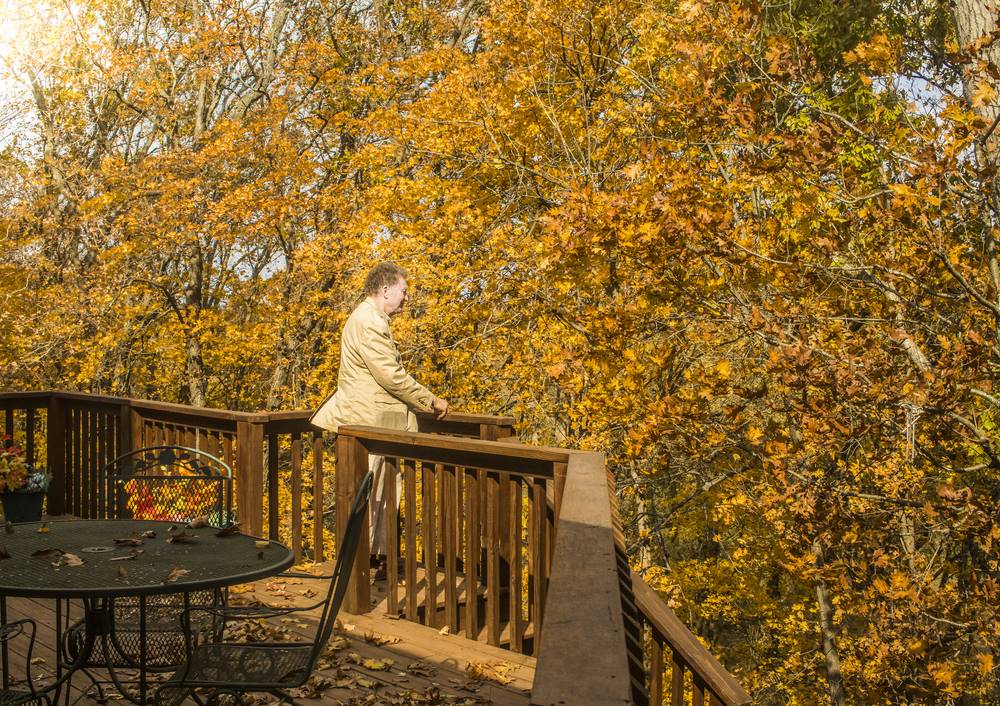 man standing on deck in the fall