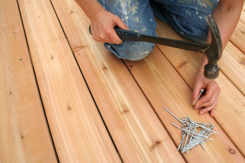 man repairing wooden deck