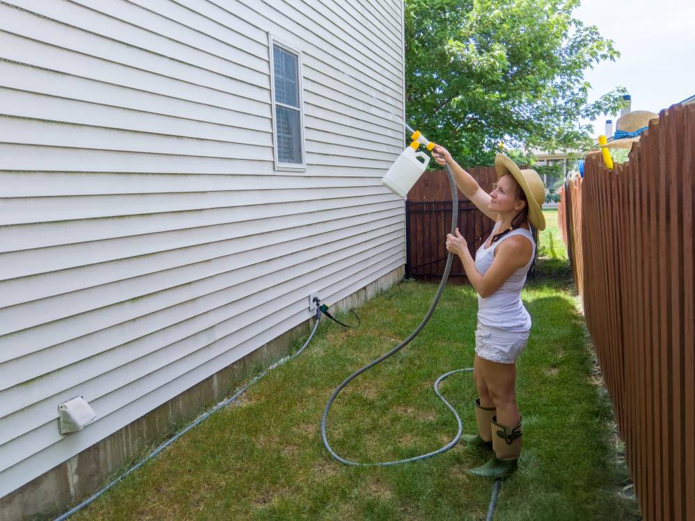 woman cleaning her siding