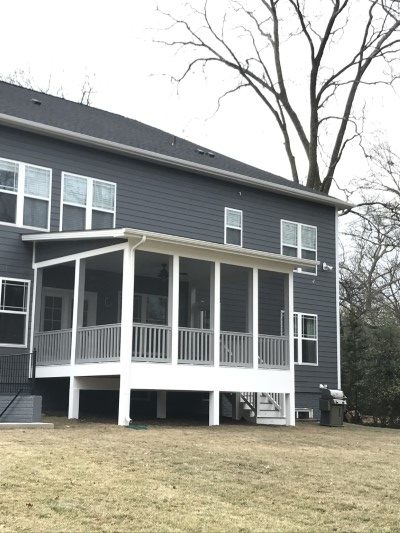 large screen porch on dark gray house