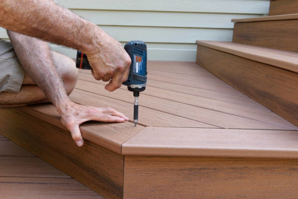 man installing composite deck