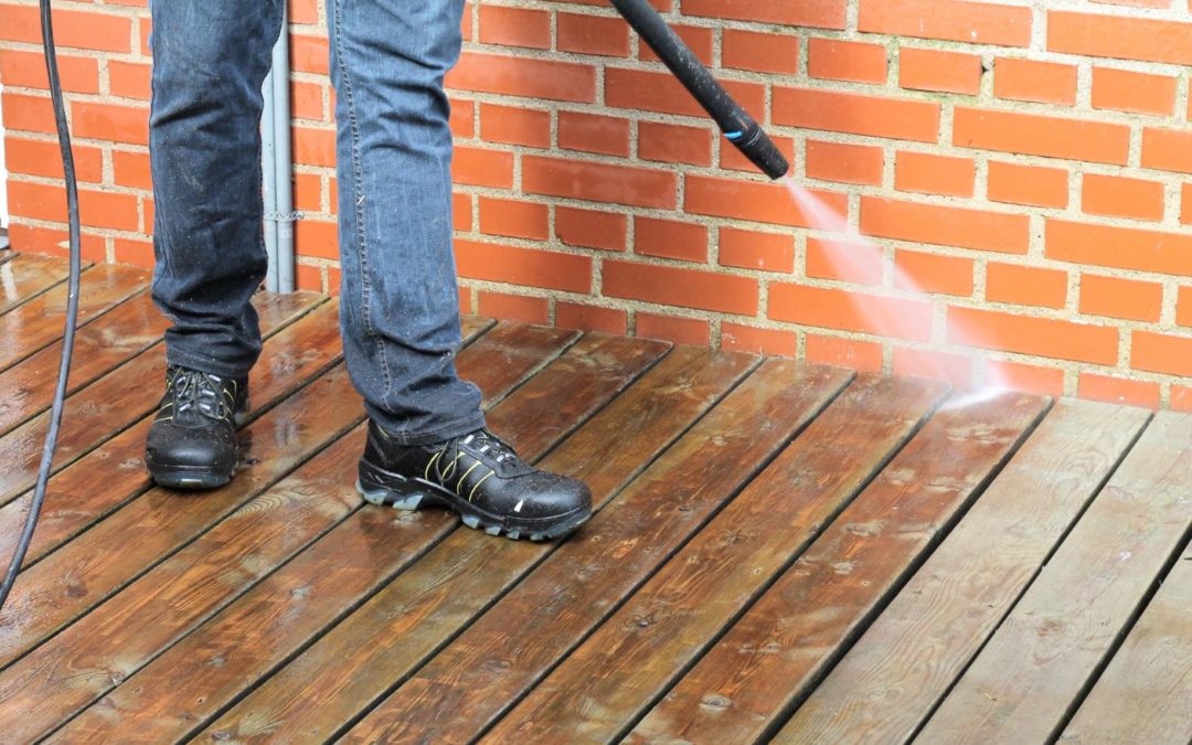 man cleaning wooden deck