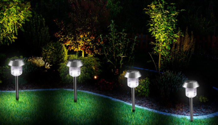 Garden lluminated by LED Lighting. Backyard Garden at Night Closeup Photo. Feel fresh and relaxed at night to moving in the park.