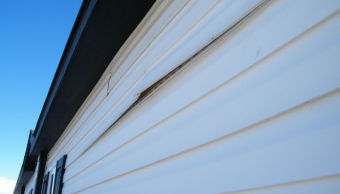 White home siding with cracked or chirped