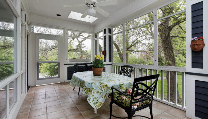 Porch in suburban home with tile floor and fan on the ceiling