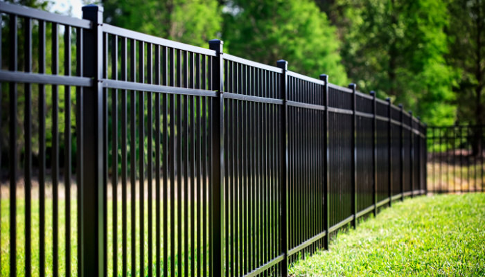 Close up of Black Aluminum Fence installed in a backyard