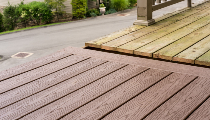 A transformation from an old wooden deck or patio to a modern composite plastic material through repair and replacement