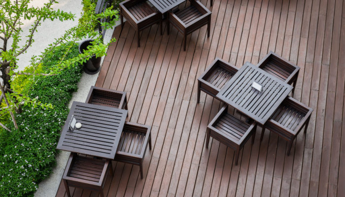 Top view of table and four chairs on living terrace or deck at a cafe