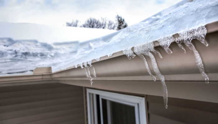 Ice dam in gutter and ice frozen on roof during winter season