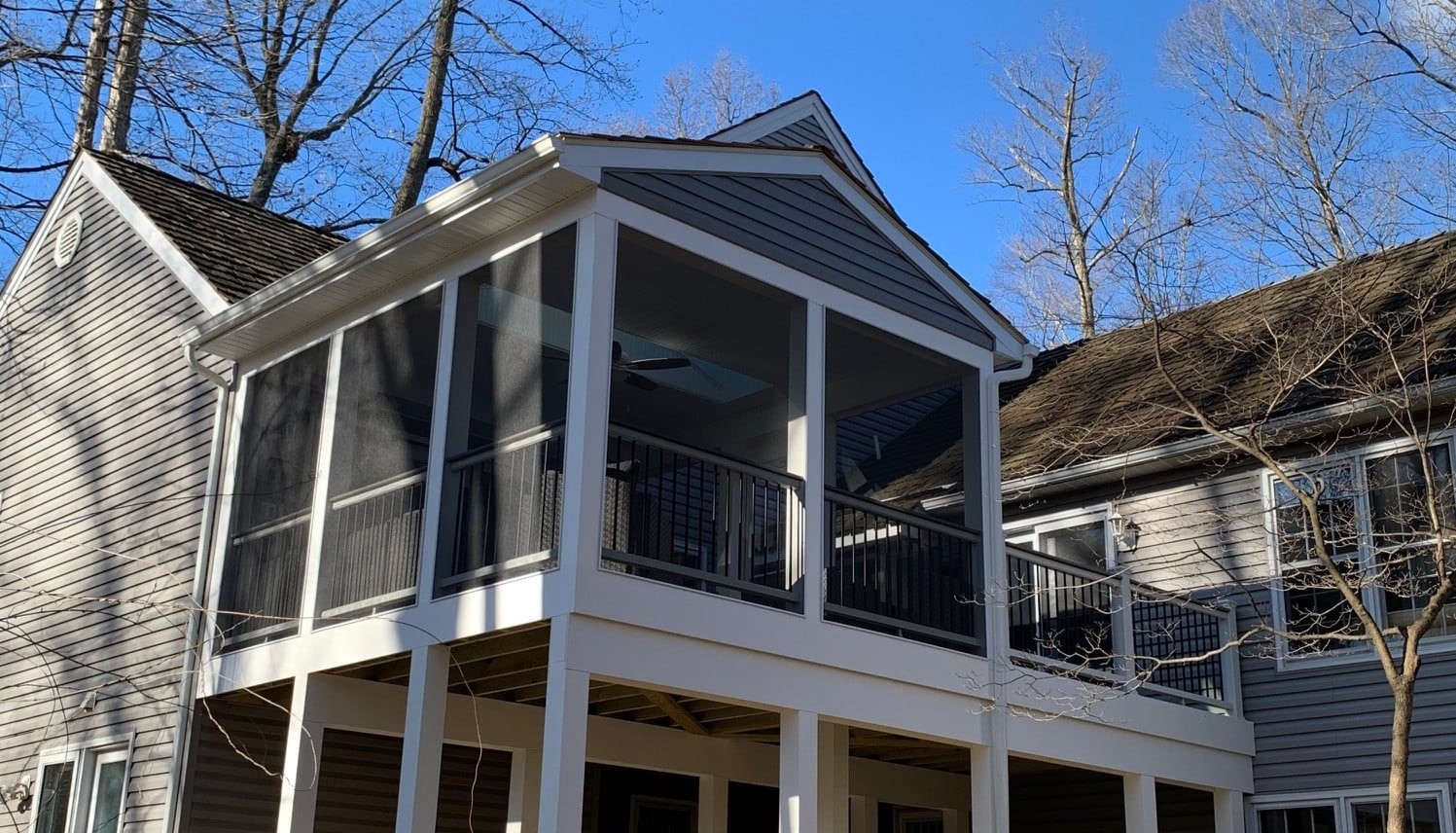 custom built deck with a screened porch in winter season